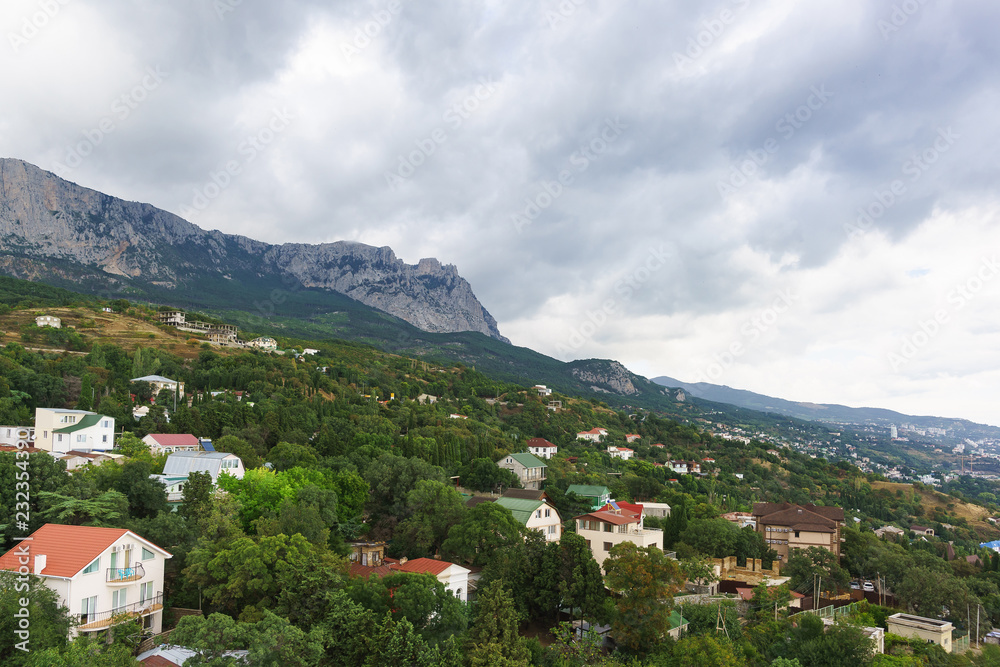 View of the resort village of Alupka and AI-Petri mountain on a cloudy day