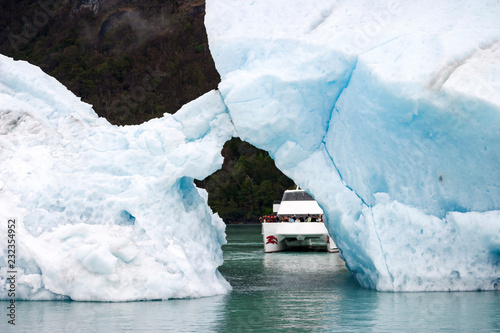 Sailing between icebergs floating in the water photo