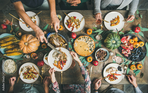 Traditional Thanksgiving day celebration party. Flat-lay of Friends or family eating different snacks and turkey at Festive Christmas table, top view