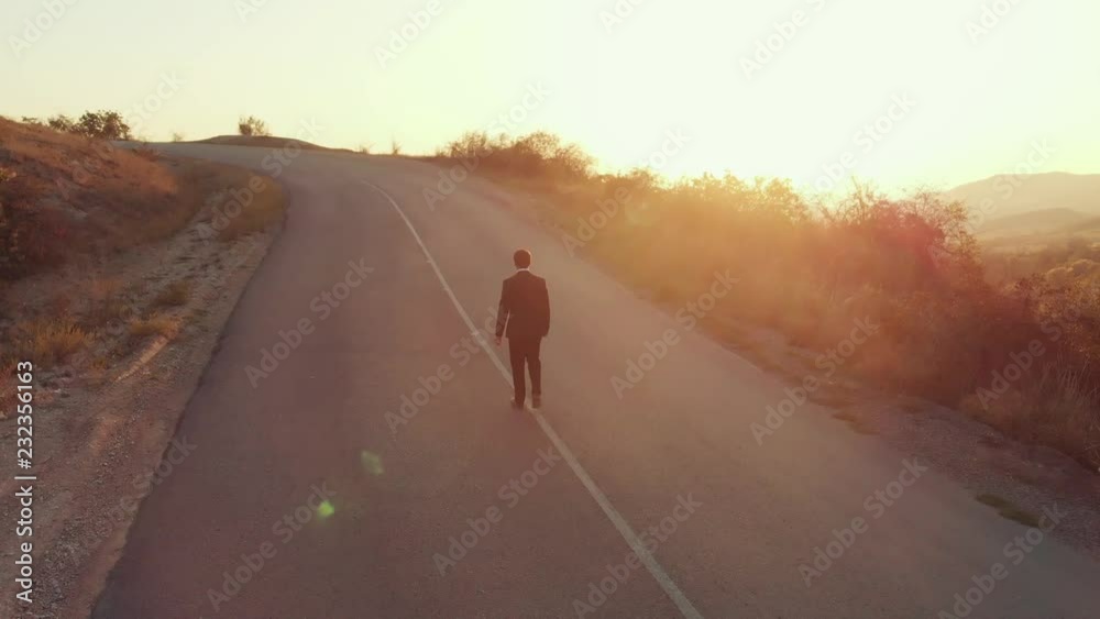Businessman walking on the road