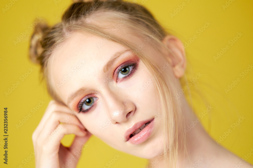 Obraz premium young girl on a yellow bright background. beautiful makeup, bright image, place for text