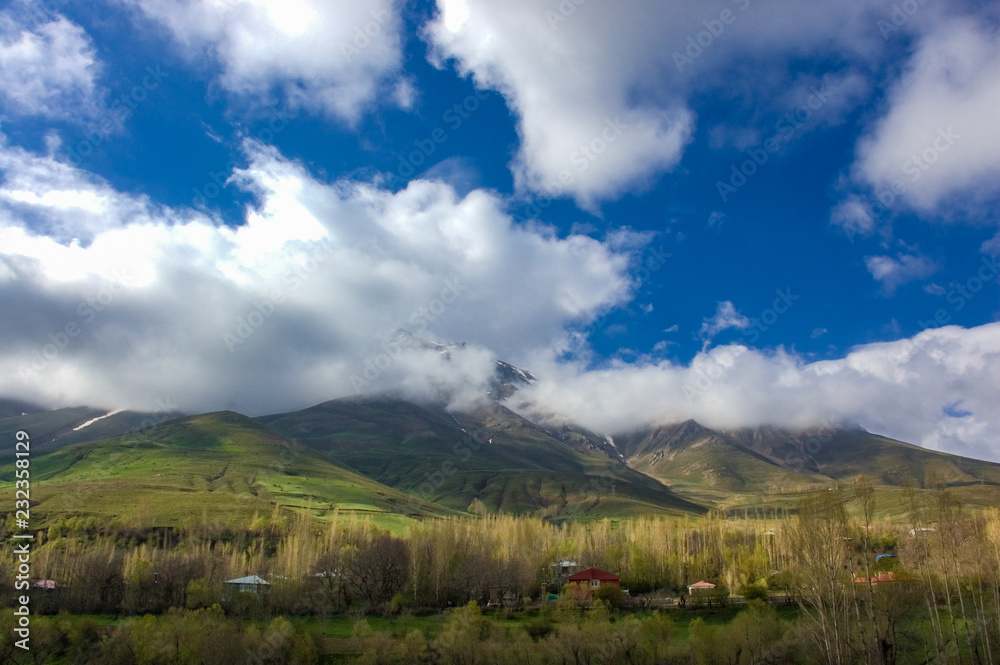 Landscape of snowy mountain, cloudy sky. Beauty in nature from Turkey. Clouds top on of mountain