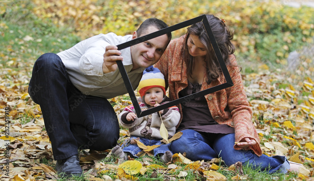 Happy young family shooting in a picture frame Happy young family shooting in a picture frame