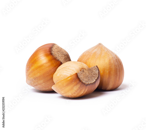 Whole and broken hazelnuts isolated closeup on white background