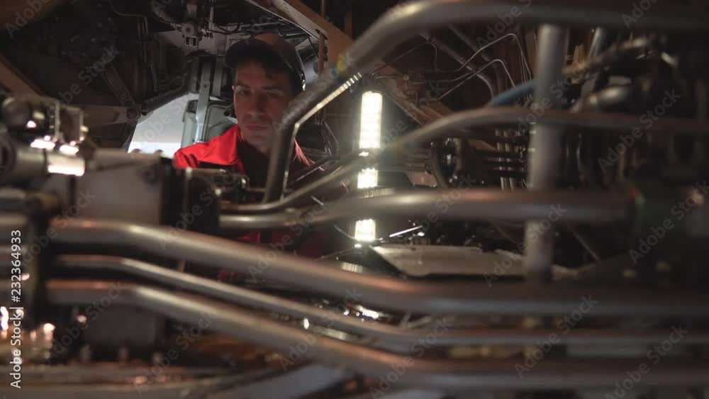The engineer repairing the aircraft in the hangar. Passenger aircraft in the hangar for maintenance. Check the hydraulics of the aircraft. Check the internal parts of the aircraft. 4K The engineer repairing the aircraft in the hangar. Passenger aircraft in the hangar for maintenance. Check the hydraulics of the aircraft. Check the internal parts of the aircraft. 4K