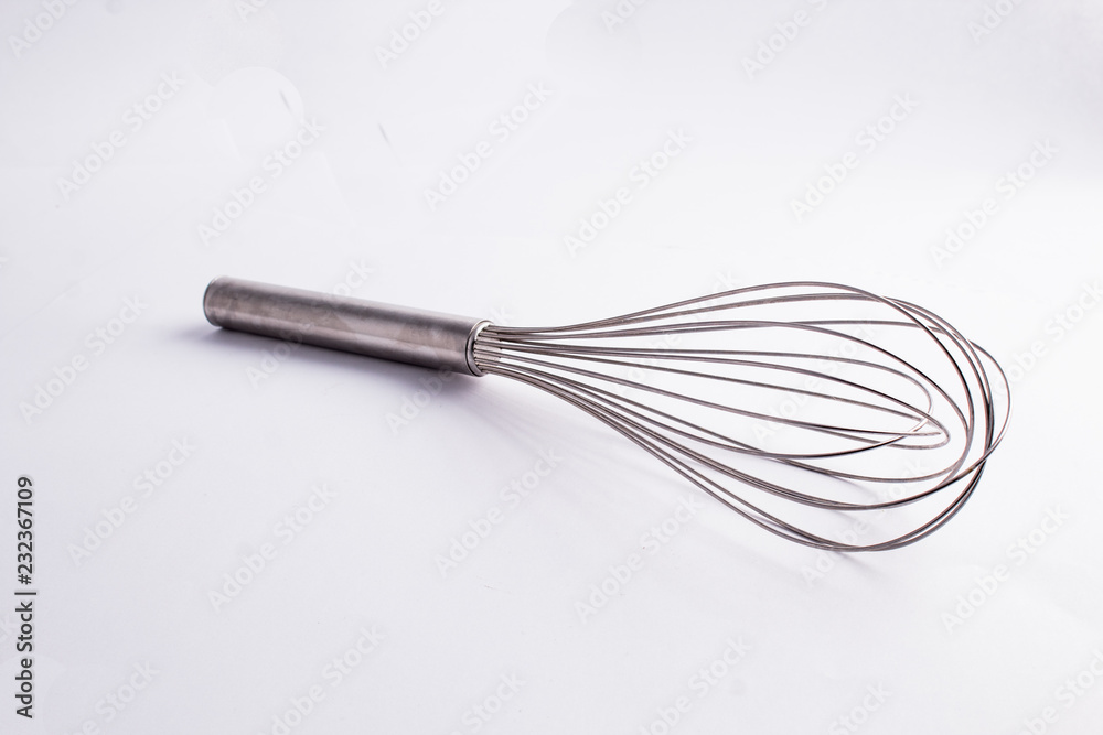 Kitche whisk or egg beater isolated on white background; sensation of fresh and clean kitchen Kitche whisk or egg beater isolated on white background; sensation of fresh and clean kitchen