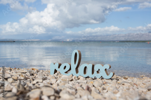 Relaxing time on the beach with sign relax
