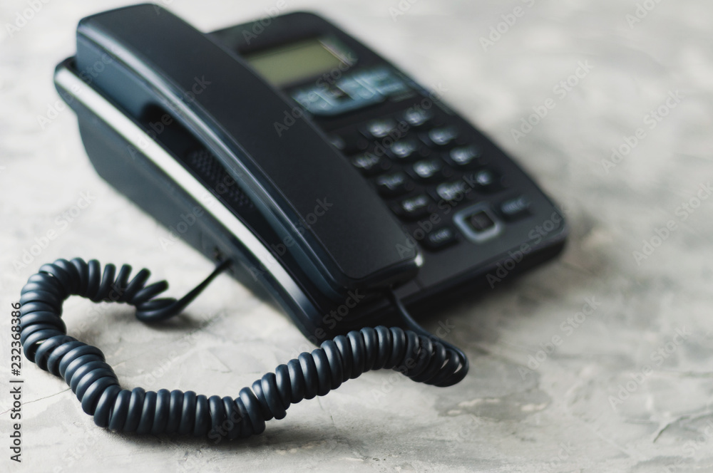 Desk phone with handset on old gray concrete table. Communication concept Desk phone with handset on old gray concrete table. Communication concept