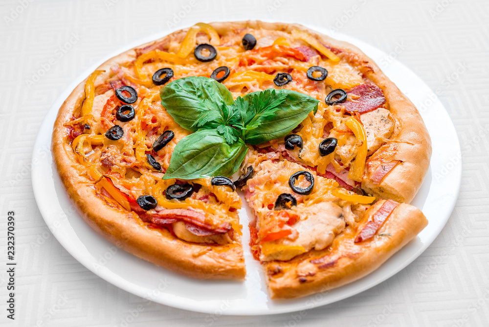 round pizza on a white plate round pizza on a white plate