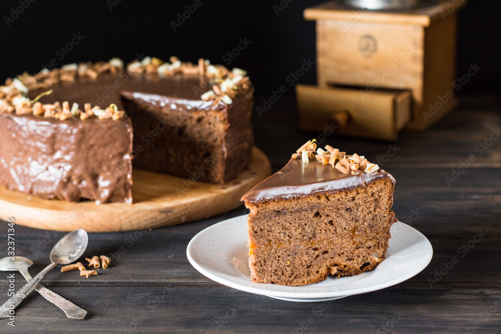 Piece of chocolate cake on a white plate on wooden. Traditional austrian cake. cake. Apricot pie. Breakfast concept. Coffee time. Still life of food. Chocolate decoration. Christmas cake. Piece of chocolate cake on a white plate on wooden. Traditional austrian cake. cake. Apricot pie. Breakfast concept. Coffee time. Still life of food. Chocolate decoration. Christmas cake.