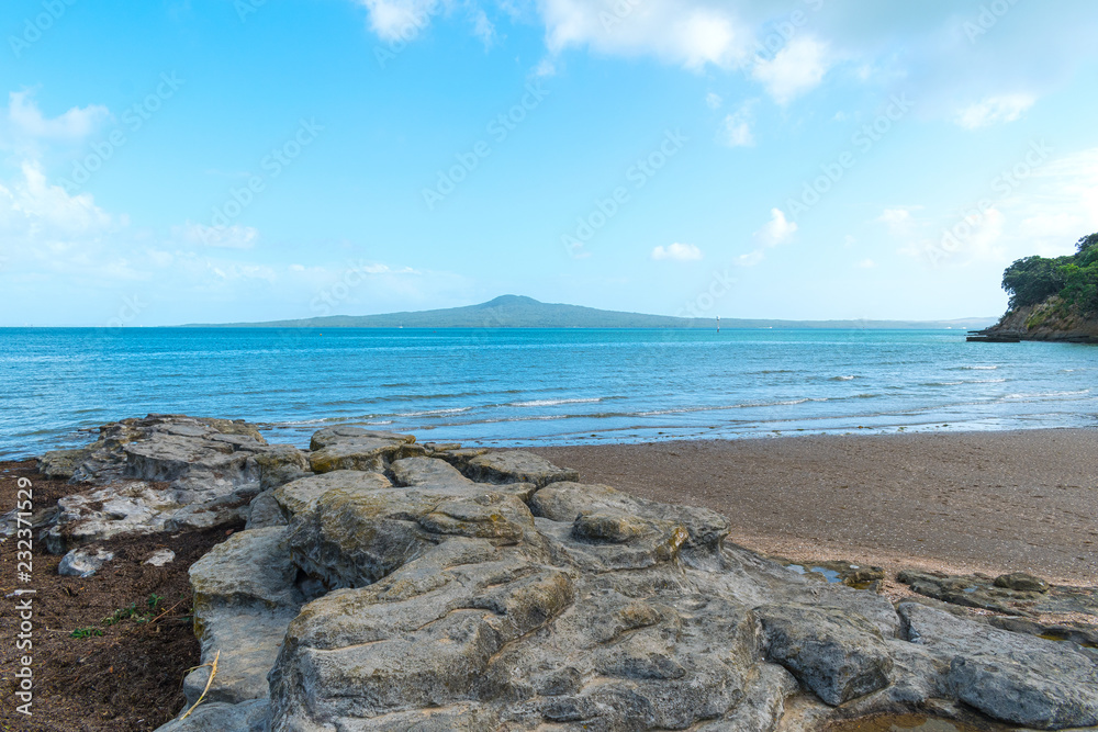 Boulder Rock and Landscape Scenery of St Heliers Beach Auckland New Zealand; View to Rangitoto Island; Calm Sea at Morning Time