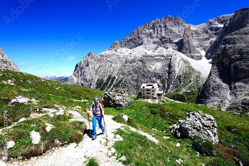 Female hiker in front of the Zsigmondy or Comici hut, Sexten Dolomites, Alta Pusteria, South Tyrol, Italy, Europe photo