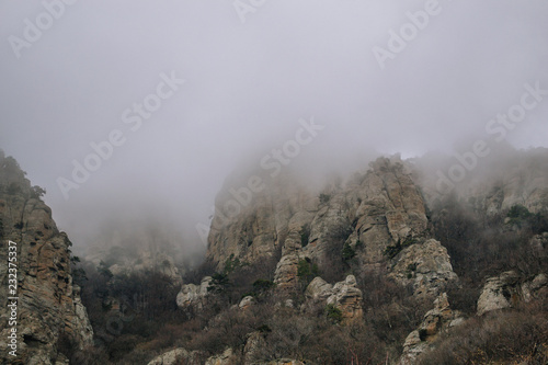 Rocks, bushes and fog in autumn Crimea mountains. Beautiful landscape. © tsirika