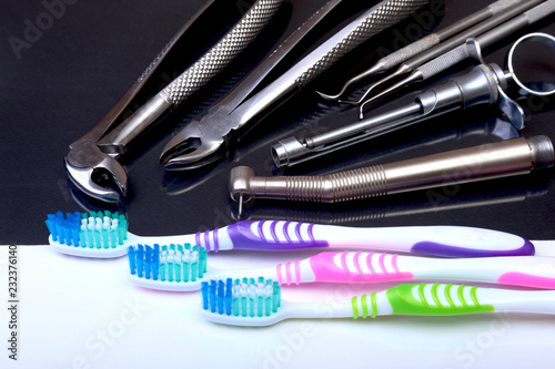 dental care toothbrush with dentist tools on mirror background. Selective focus.