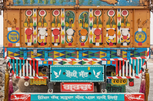 Brigt and colorful traditionally pained Indian lorry on the street