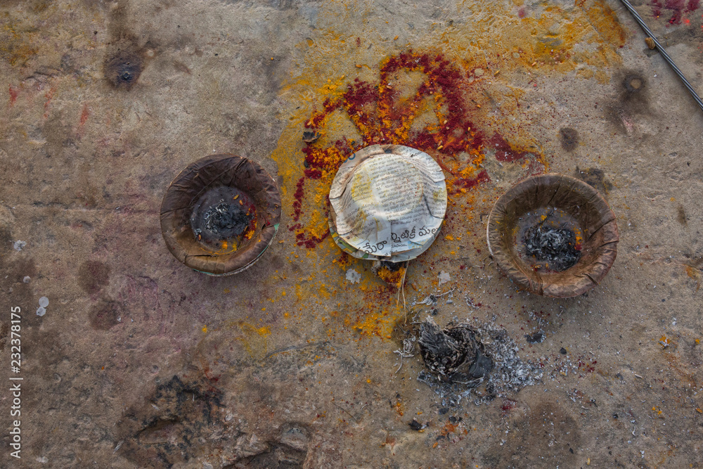 sacrifices and offerings with golden foils in front of Dhamekh Stupa in Sarnath, Varanasi, Uttar Pradesh, India