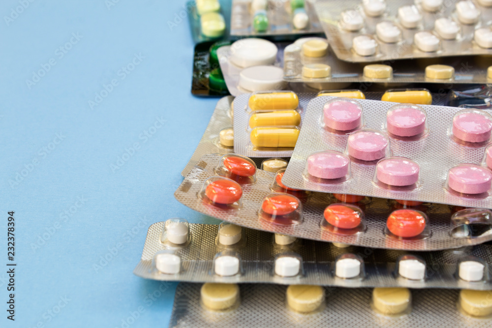Medicinal tablets on blue background. Medicinal tablets on blue background.
