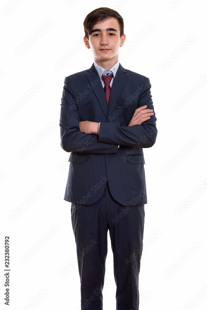 Studio shot of young handsome Persian teenage businessman standi Studio shot of young handsome Persian teenage businessman standi