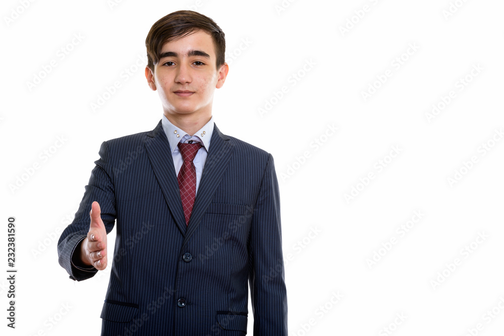 Studio shot of young handsome Persian teenage businessman giving Studio shot of young handsome Persian teenage businessman giving