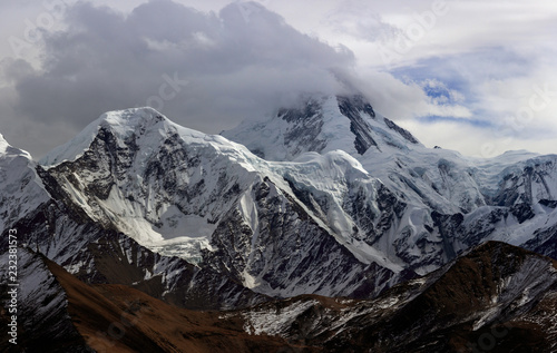 Mount Gongga  Minya Konka  Holy Tibetan Snow Mountain  - Gongga Shan in Sichuan Province  China. View from the west at Yaha Pass  summit shrouded in clouds. Highest Mountain in Sichuan Province China.