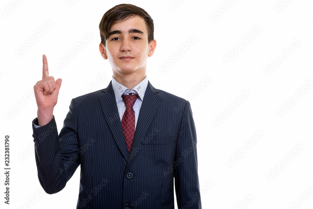 Studio shot of young handsome Persian teenage businessman pointi Studio shot of young handsome Persian teenage businessman pointi