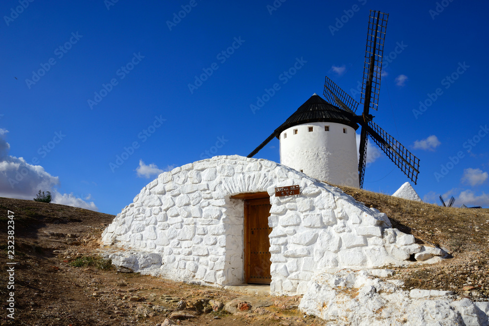 Campo de Criptana, Spain - November 1 2018: Entrance to the Silo Cave next to the mills of Campo de Criptana. Campo de Criptana, Spain - November 1 2018: Entrance to the Silo Cave next to the mills of Campo de Criptana.