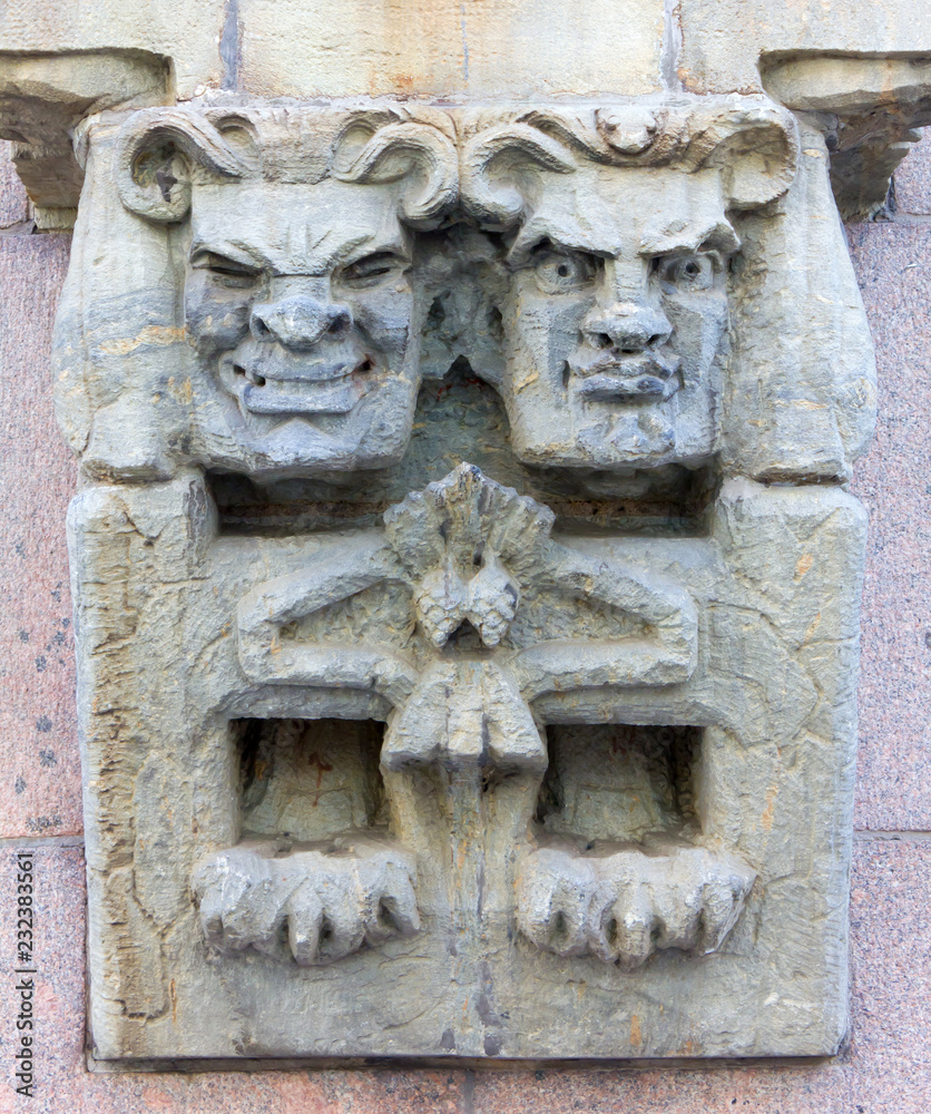 Caricature Wall Sculpture Depicting Two Faces With Different Expressions