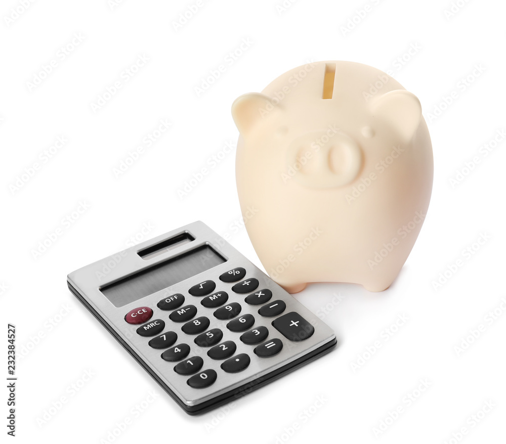 Piggy bank with calculator isolated on white Piggy bank with calculator isolated on white