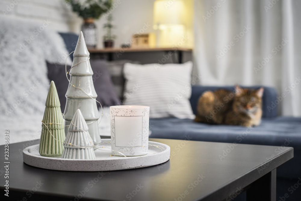 Christmas decorations with candle on coffee table