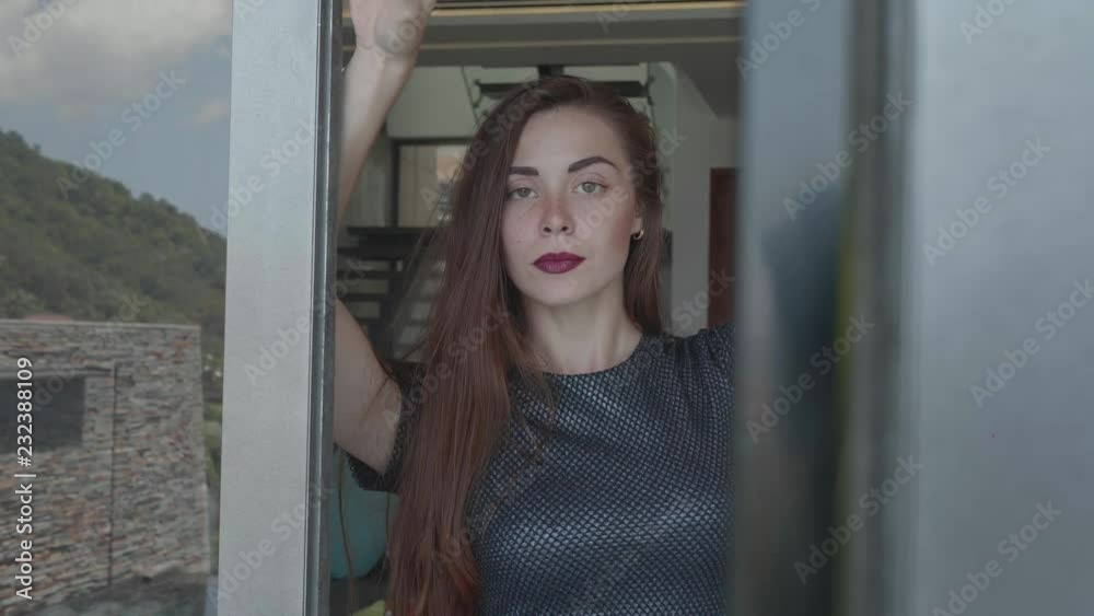 Beautiful red hair girl in elegant dress posing in luxurious modern interior - video in slow motion Beautiful red hair girl in elegant dress posing in luxurious modern interior - video in slow motion