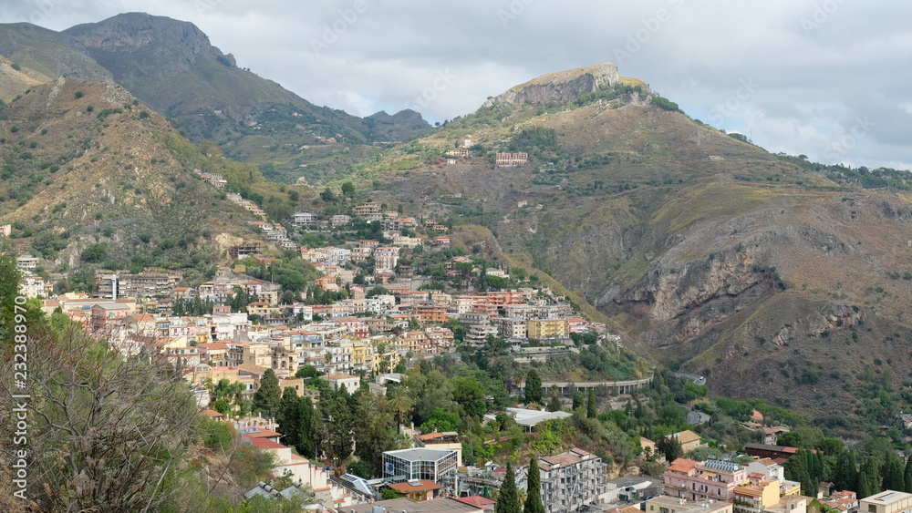 Taormina, Province of Messina, Sicily. View of part of the city, built on the hillside. Taormina was founded in the 4th century BC and is one of Sicily's most popular summer destinations.