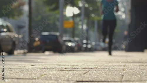 Wallpaper Mural Woman running in a city. Slow motion shot. Torontodigital.ca