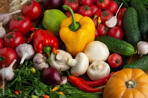 Vegetables and nuts on a brown wooden background