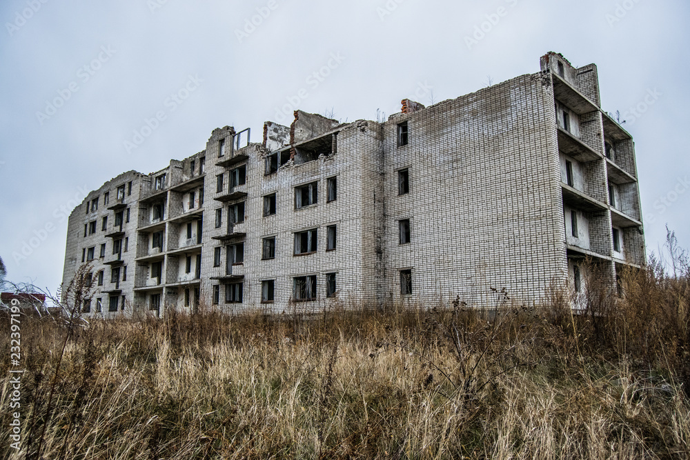 Old destroyed an abandoned multi-storey building in a military t