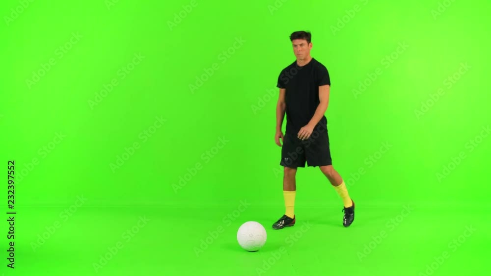 Soccer player prepares for a free kick, kicks and celebrate over a green screen.