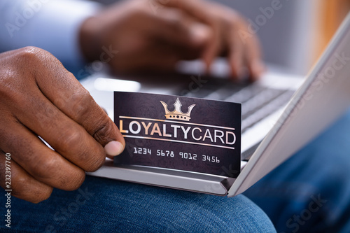 Man's Hand Holding Loyalty Card