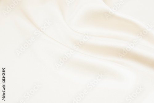 The texture of the satin fabric of beige color for the background 