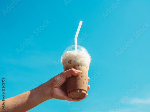 Hand holding a cup of iced coffee
