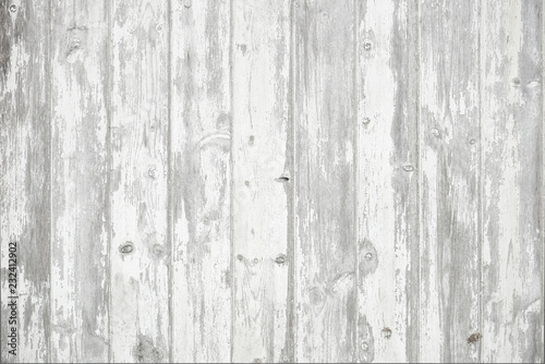 Old weathered wood surface with long boards lined up. Wooden planks on a wall or floor with grain and texture. Light neutral flat faded tones.