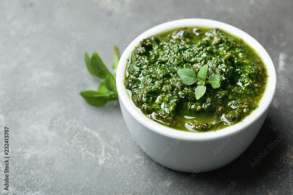 Homemade basil pesto sauce in bowl on table Homemade basil pesto sauce in bowl on table