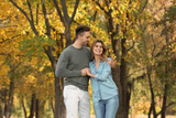 Happy lovely couple on walk in autumn park