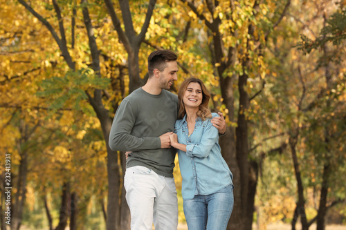 Happy lovely couple on walk in autumn park