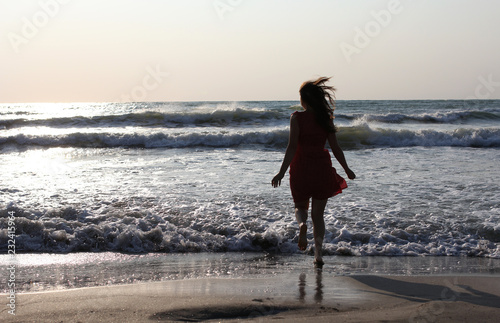 Young pretty woman enjoying the waves on the beach