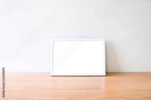 Mock up horizon photo frame on woodden table.