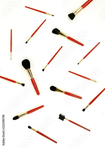makeup brushes pattern set in red color on white background. top view
