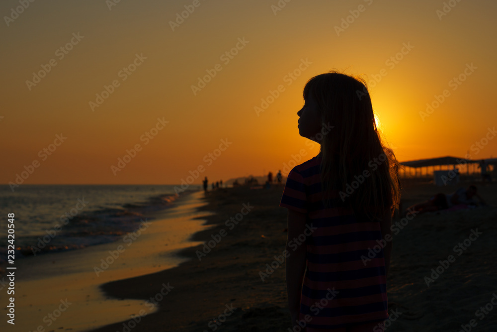 Portrait in the background light at sunset by the sea