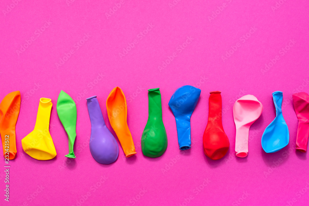 Set of colored balloons on pink background Flat lay top view Set of colored balloons on pink background Flat lay top view