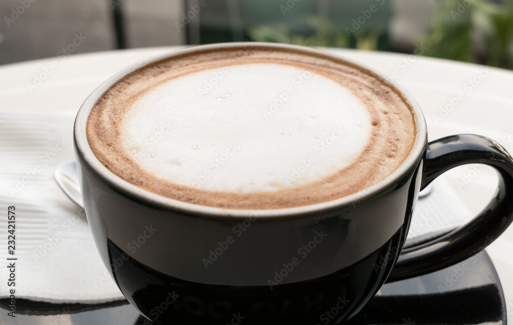 Milk foam in top of coffee cup. Milk foam in top of coffee cup.
