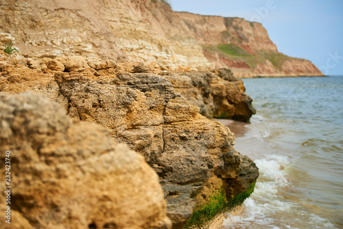 beautiful seaside landscape  closeup of stone on the beach  sea coast with high hills  wild nature