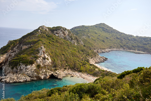 Beautiful seascape with turquoise water, cliffs and the sea. Sunny warm tropical day. Background for travel on the Mediterranean. Greece. Europe